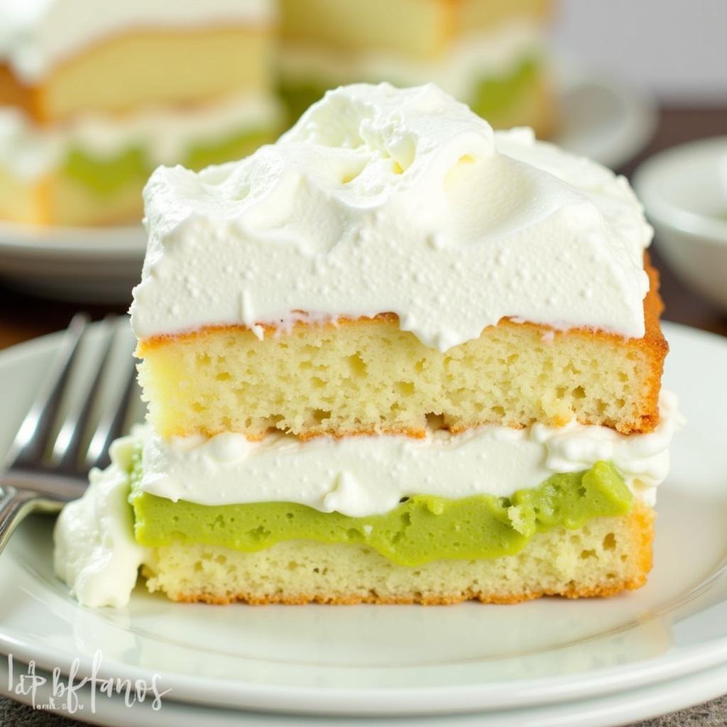 Layers of angel food cake, pistachio pudding, and cool whip