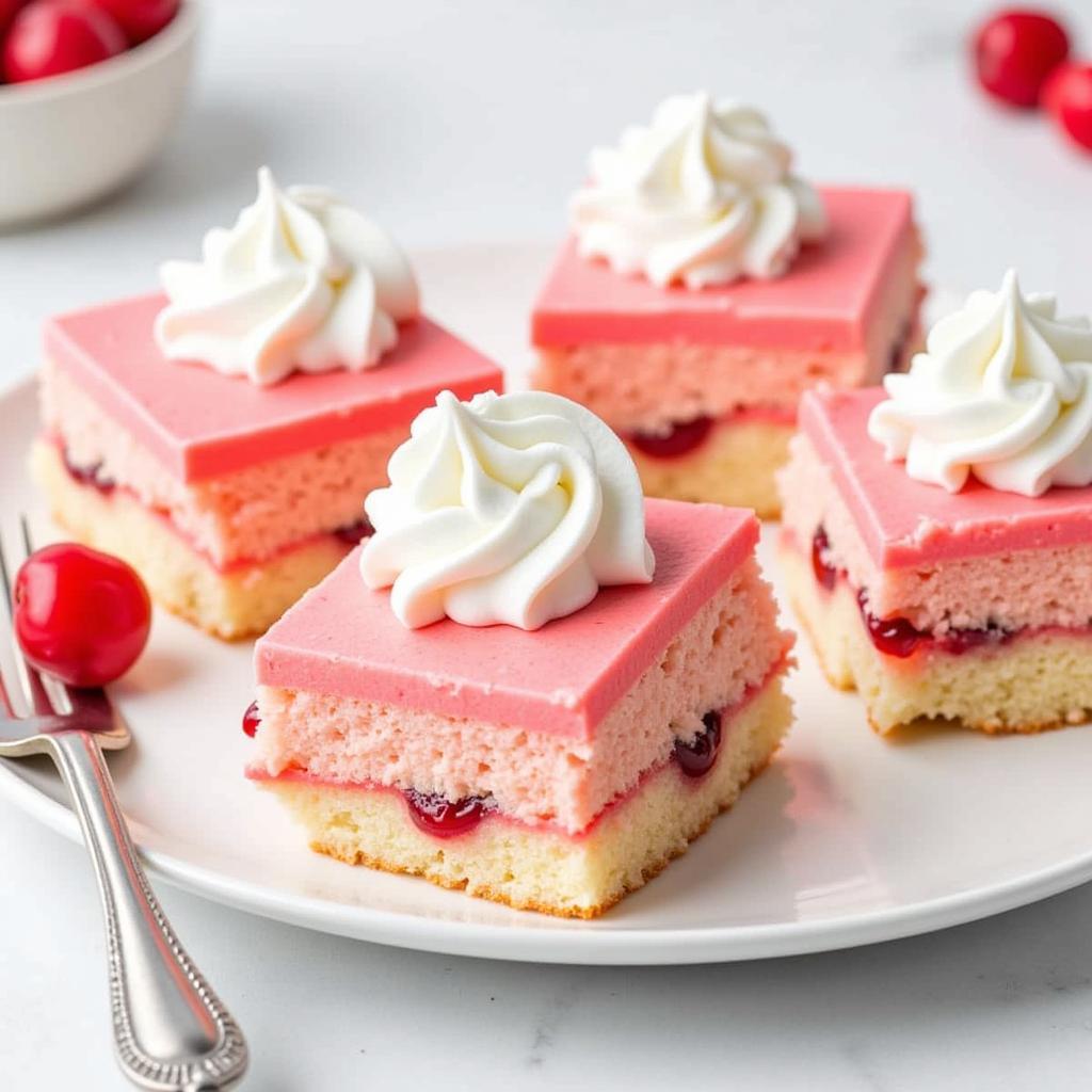 Slices of cherry angel food cake with whipped cream