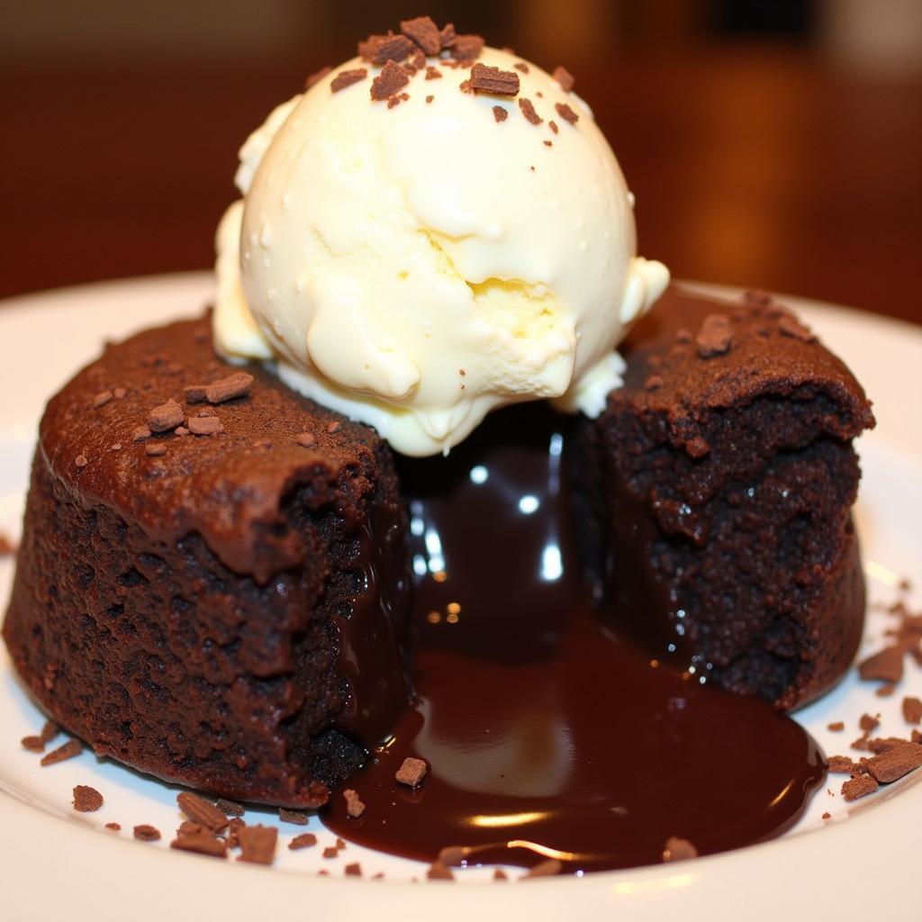 A warm chocolate lava cake with a scoop of vanilla ice cream melting on top.