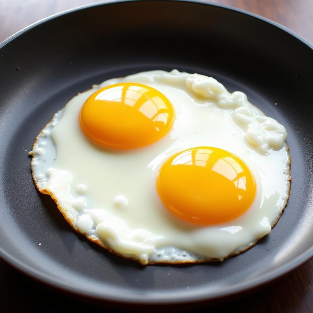 Sunny-side-up eggs in a nonstick pan