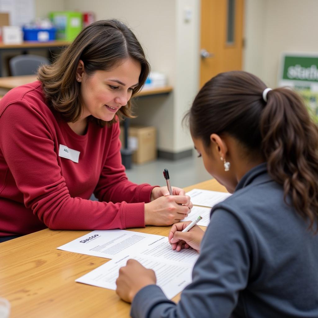 A volunteer assisting a community member with the registration process at the St. Blaise Food Pantry.