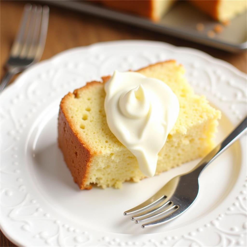 A slice of angel food cake with cream cheese icing on a plate