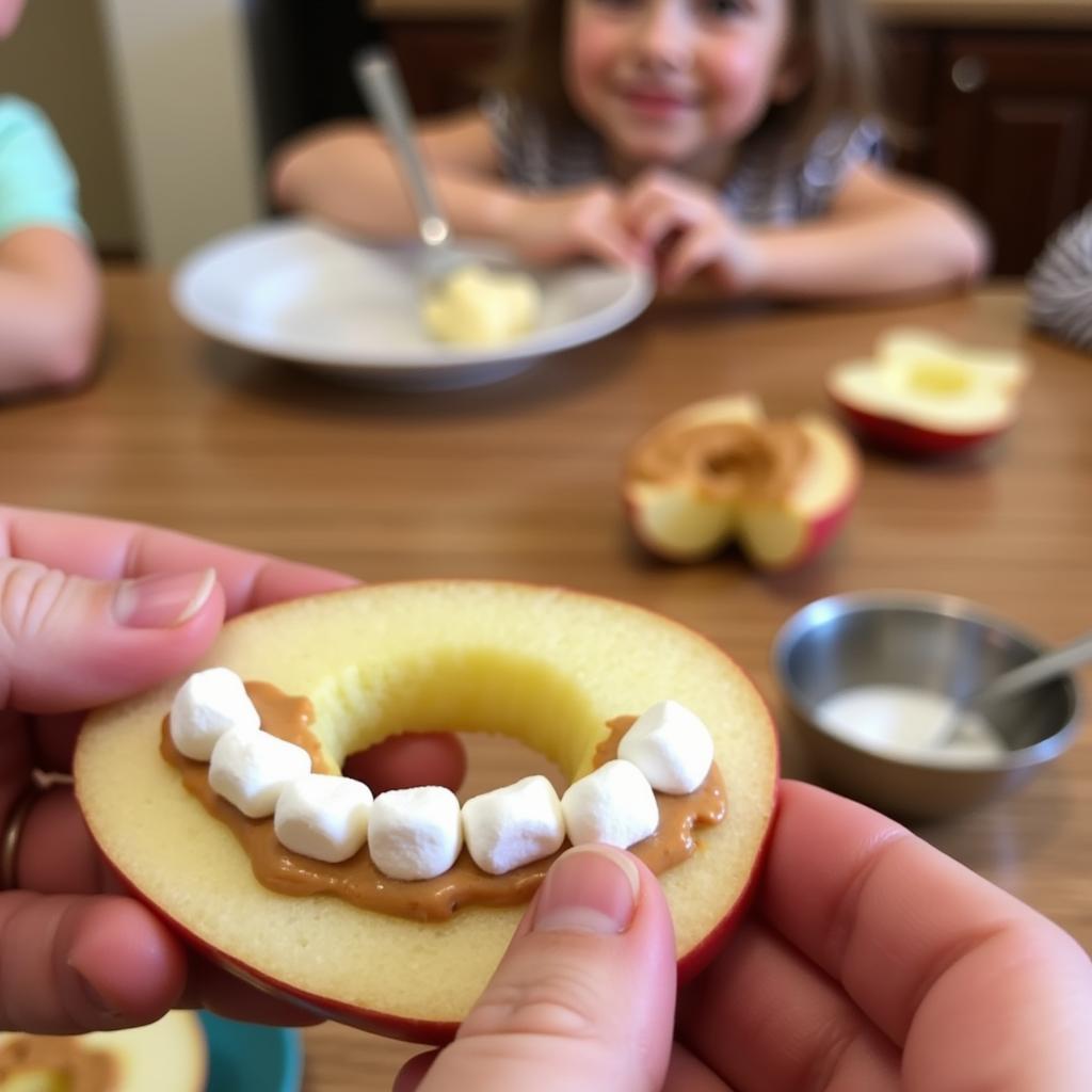 Preschoolers creating apple smiles with peanut butter, apple slices, and mini marshmallows.