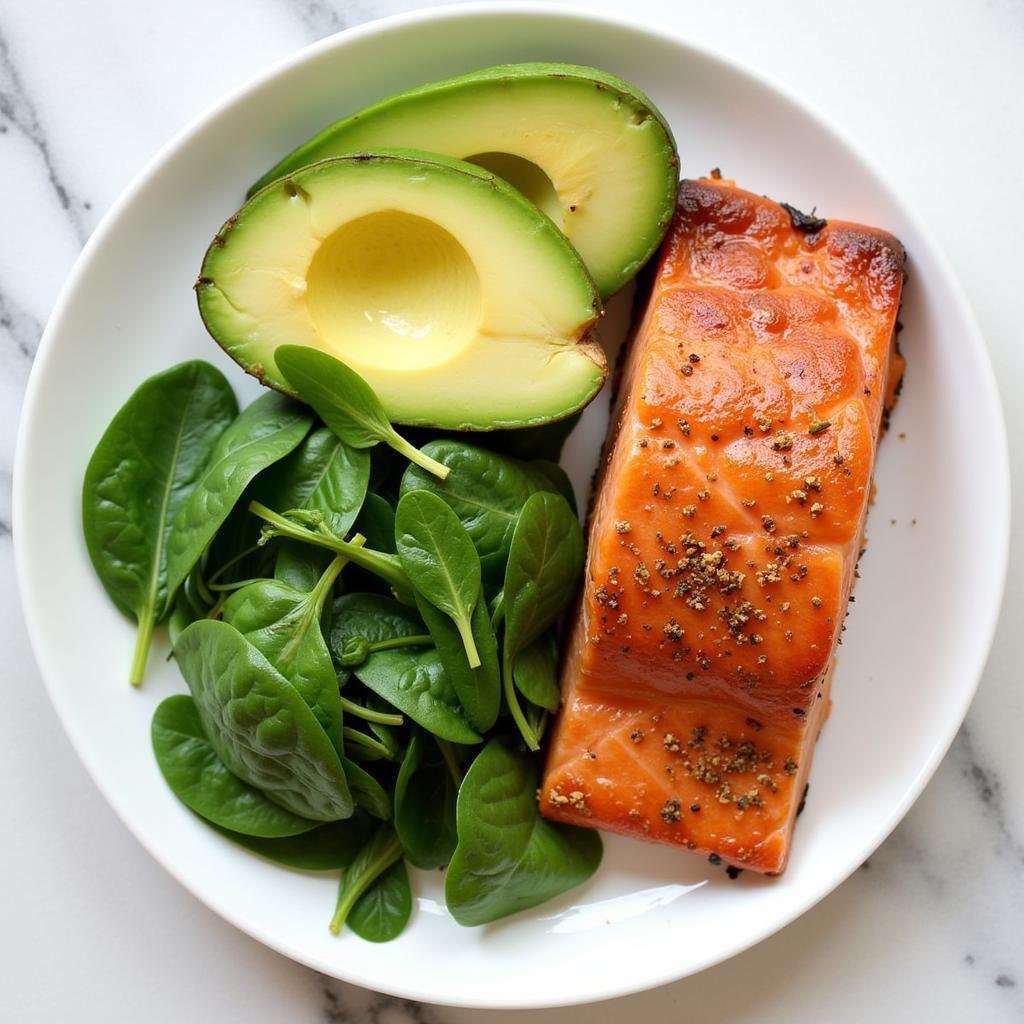 Avocado slices on a plate with other keto-friendly foods