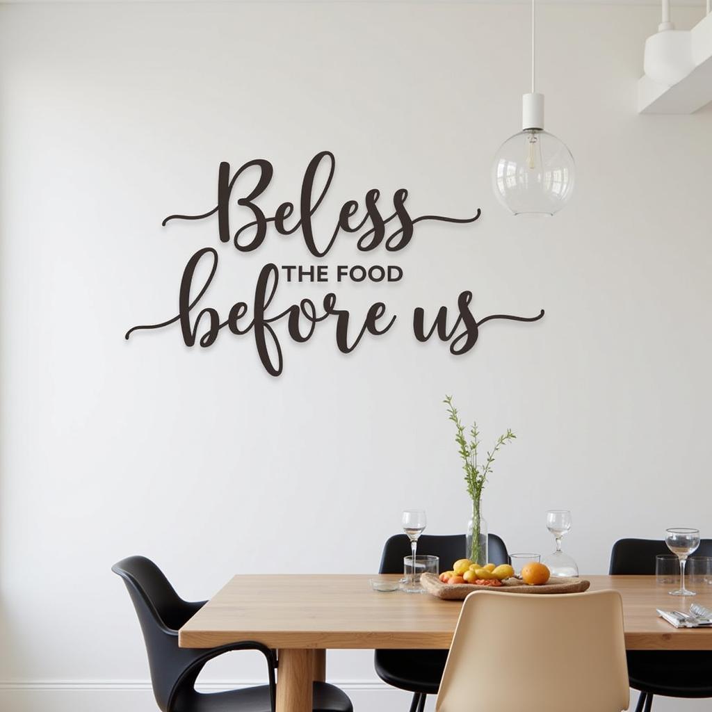 Elegant metal "Bless the Food Before Us" wall decor in a modern dining room