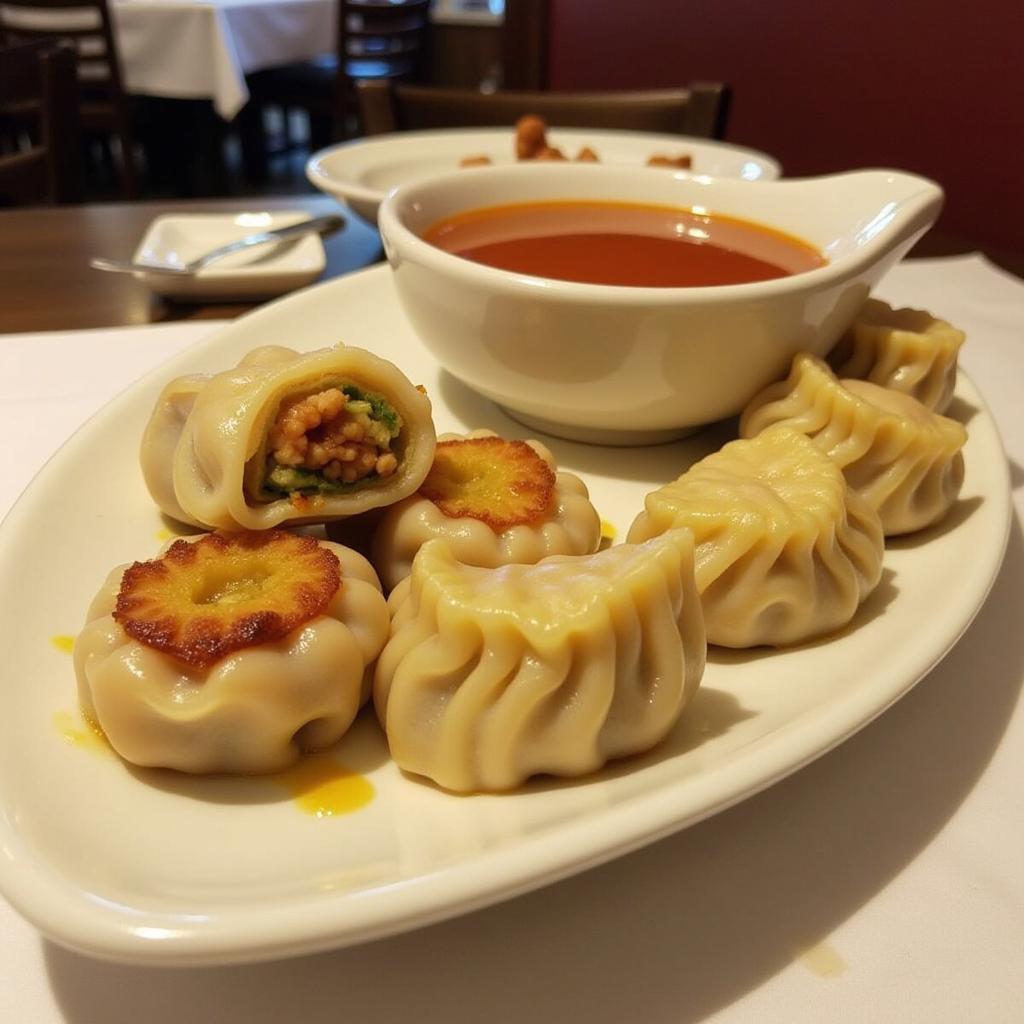 A plate of steaming hot dumplings, served with a dipping sauce, in a North Branford, CT Chinese restaurant.