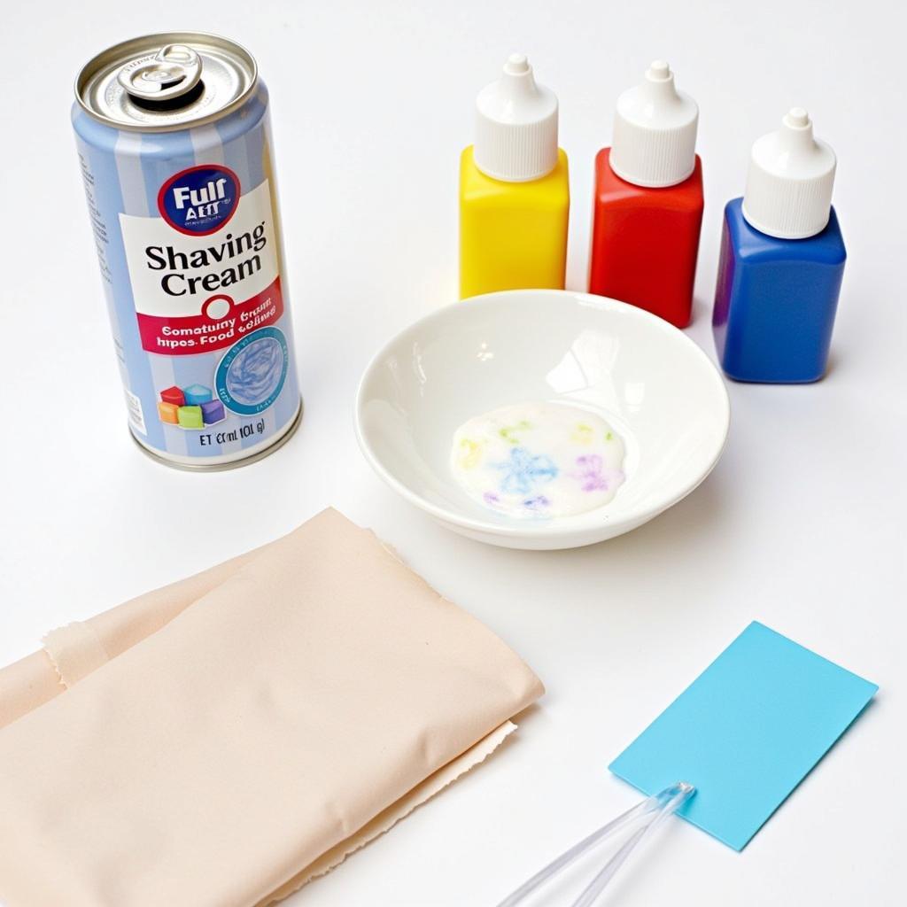 Shaving cream, food coloring, and paper supplies for art project