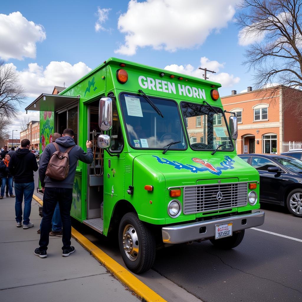 Green Horn food truck parked in a bustling Denver street, serving customers