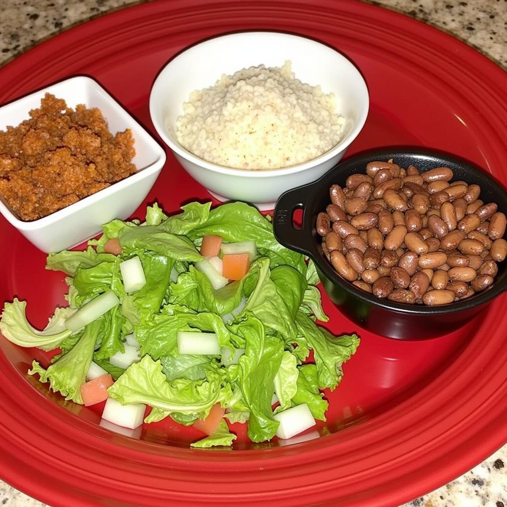 Close-up of the main ingredients of La Bandera - meat, rice, beans, and salad ingredients.