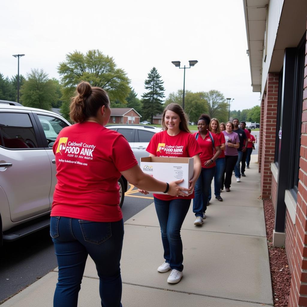 Caldwell County Food Bank volunteers distributing food boxes to families in need.