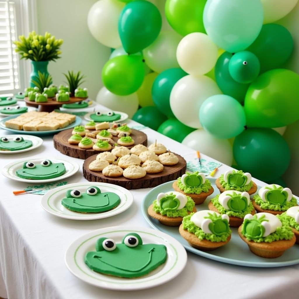 A table laden with frog-themed food, including cupcakes, cookies, and savory snacks.