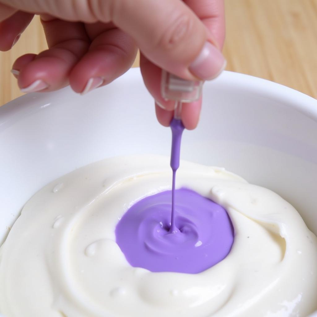 Mixing violet food colouring to achieve different shades.