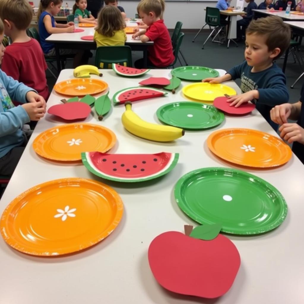 Colorful paper plate fruits arranged on a table.