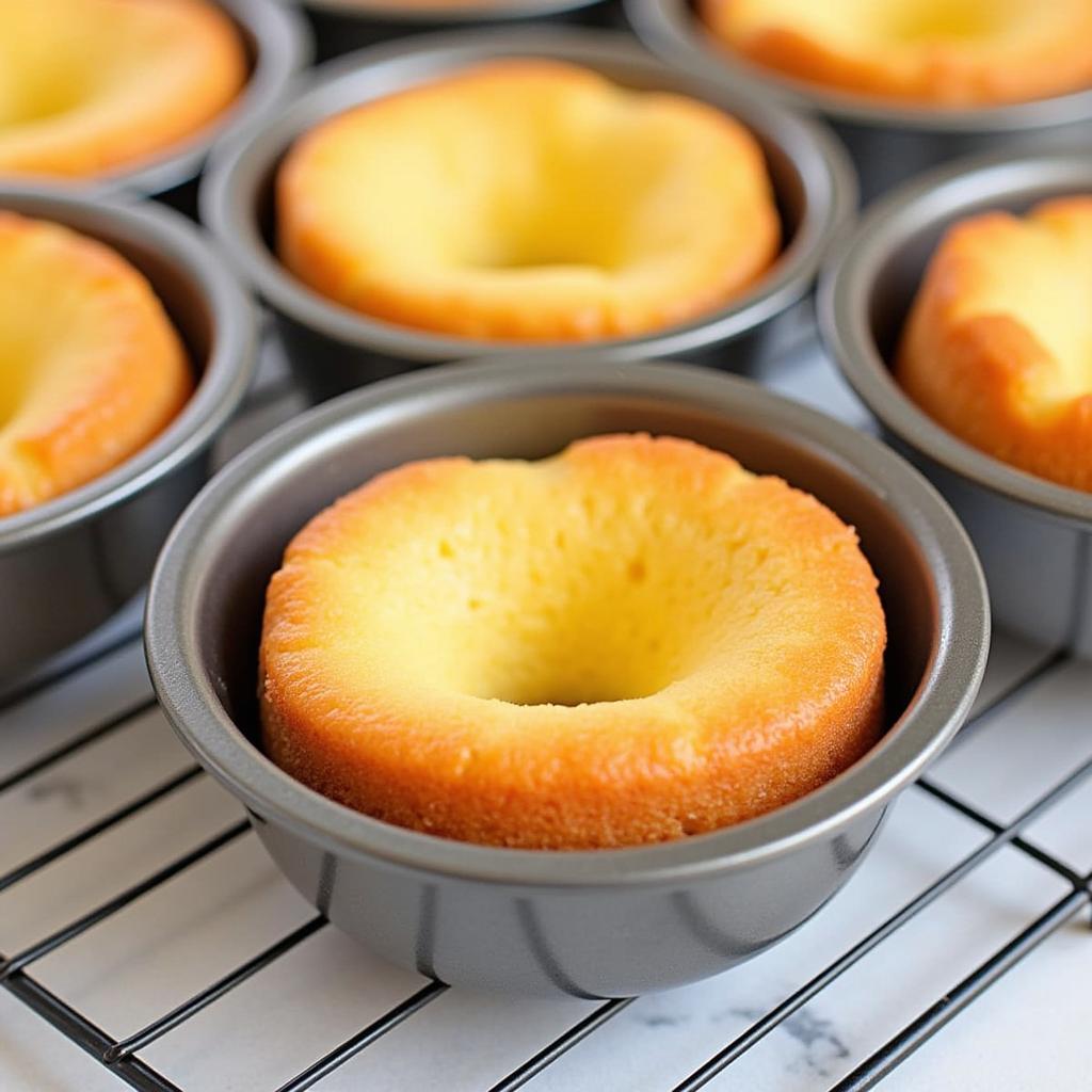 Perfectly baked mini angel food cakes in individual pans.